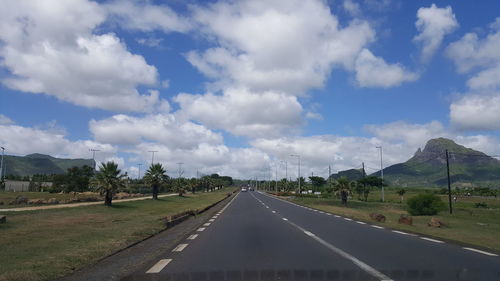 Road passing through landscape against sky