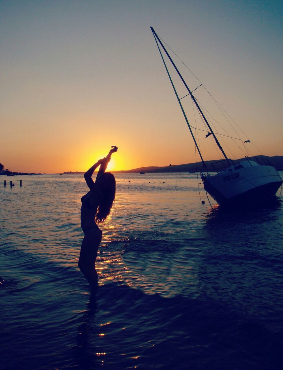 sunset, water, silhouette, clear sky, sea, bird, orange color, sun, animal themes, scenics, nature, nautical vessel, beauty in nature, one animal, wildlife, tranquility, one person, tranquil scene, rippled, animals in the wild