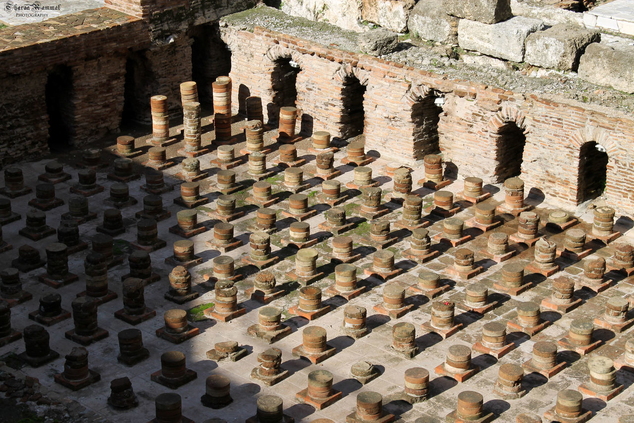 built structure, architecture, pattern, brick wall, wall - building feature, metal, old, high angle view, stone wall, in a row, repetition, stone material, large group of objects, day, textured, sunlight, close-up, outdoors, history, abundance