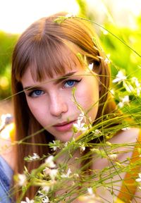 Portrait of young woman with red eyes closed