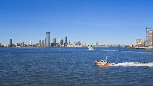 Scenic view of sea and buildings against sky