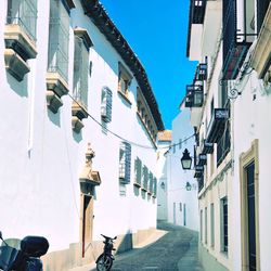 Narrow street amidst buildings against sky