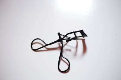 Close-up of eyeglasses on table against white background