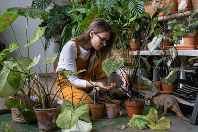 Young woman with potted plants