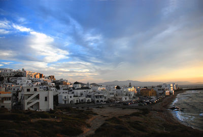 High angle view of townscape by sea against sky