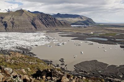 Scenic view of mountains against cloudy sky