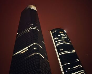 Low angle view of modern office building at night