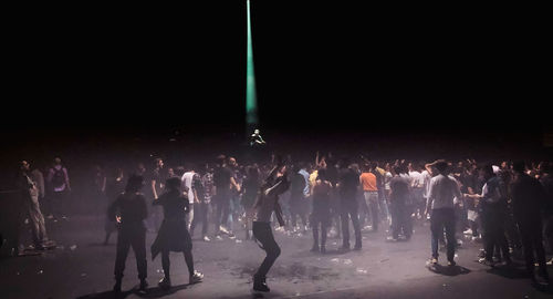 People enjoying music concert at night