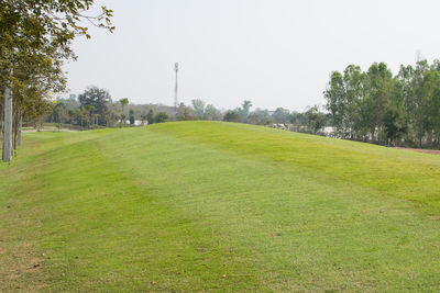 View of golf course against clear sky