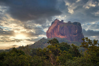 Rock formations against sky during sunset