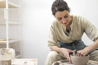 Mid adult woman looking away while sitting at home