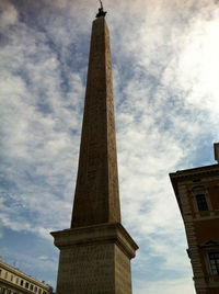 Low angle view of tower against cloudy sky