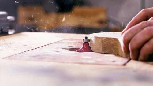 Close-up of hand operating machine in factory