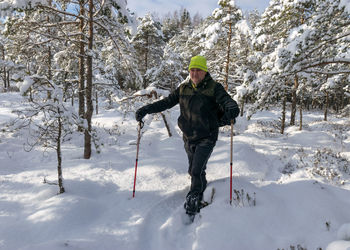 Man standing on snow covered land