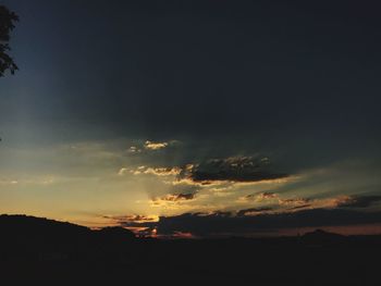 Low angle view of silhouette landscape against sky during sunset