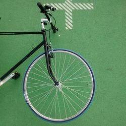 High angle view of bicycle on green surface