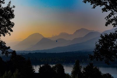 Scenic view of silhouette mountains against sky at sunset