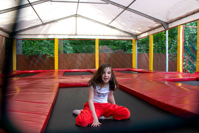 Happy lsports girl having fun while jumping on trampoline