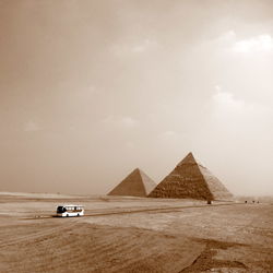 Car on desert against sky