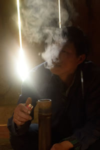 Close-up of man smoking cigarette