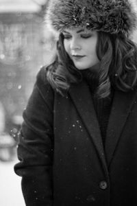 Close-up of young woman standing in snow