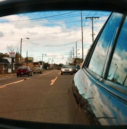 Cars on road against sky