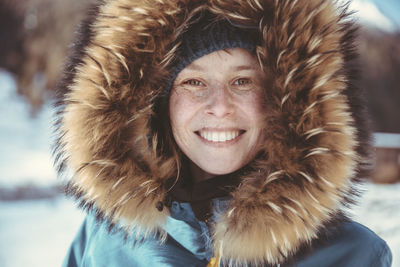 Portrait of happy woman with fur hood