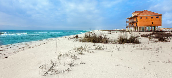 Scenic view of beach by sea against sky