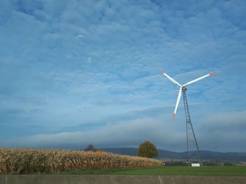 Windmill on field against sky