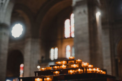 Illuminated candles in building