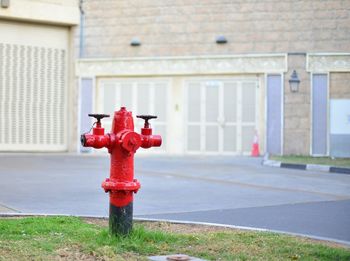 Fire hydrant at roadside against building