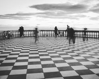 Ghosts on the mascagni terrace, silent  people walking on chessboard