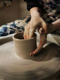 Midsection of person working in kitchen