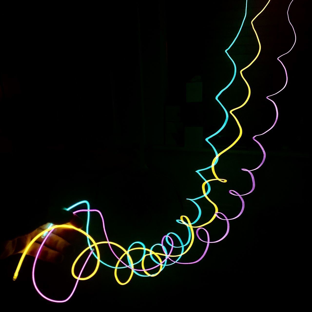 LIGHT PAINTING AGAINST BLACK BACKGROUND AT NIGHT