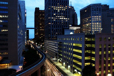 High angle view of illuminated cityscape against sky at night