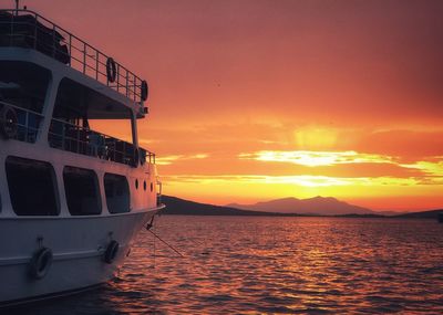 Ship in sea against sky during sunset