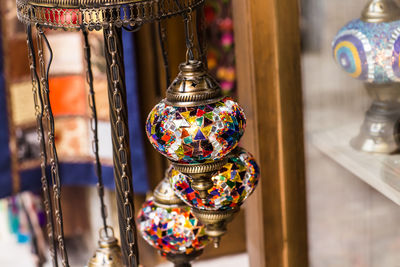 Close-up of illuminated lanterns hanging in store