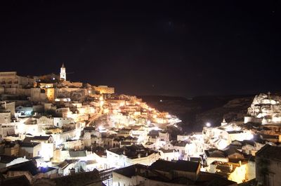 High angle view of illuminated town against sky at night