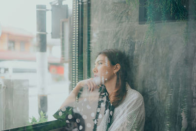 Portrait of woman looking at city