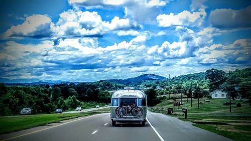 View of mountain road against cloudy sky