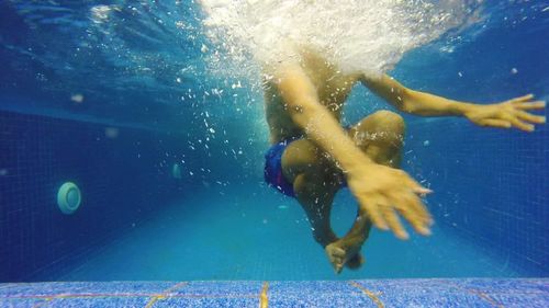 Low section of boy in swimming pool