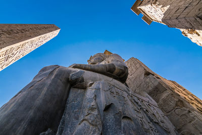 Low angle view of historical building against clear blue sky