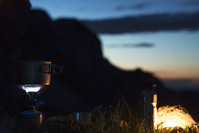 Close-up of coffee on stove against sky during sunset