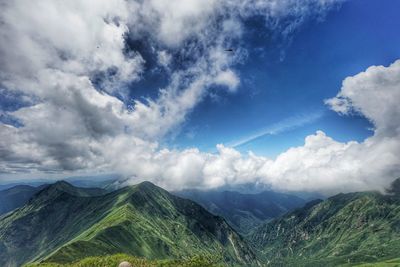 Scenic view of mountains against blue sky