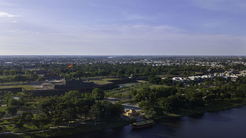 High angle view of buildings and sea against sky