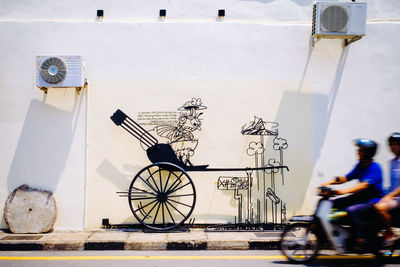 Bicycle on street against wall