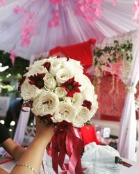 Cropped hand of woman holding bouquet