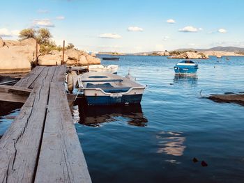 Boats moored on sea against sky