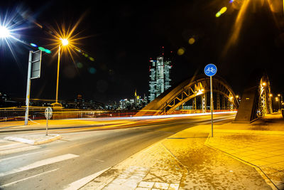 Illuminated light trails on road at night