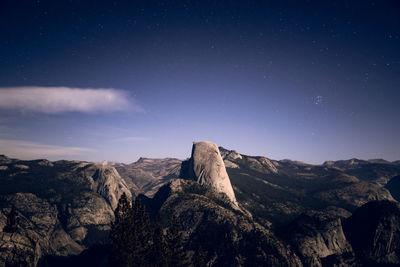 Scenic view of mountains against sky at night